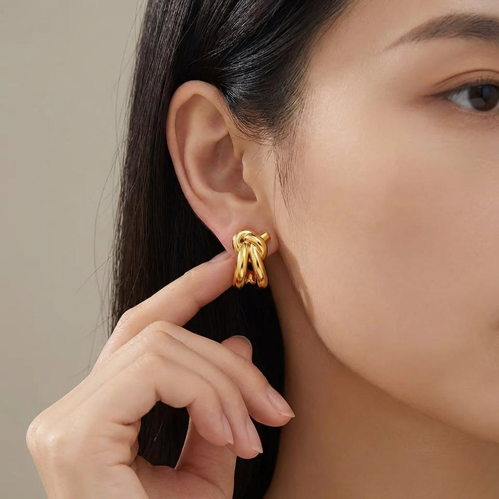 Knot huggie studs worn on the ear – Vessaly