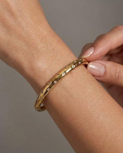 gold cuff bracelet with star set stones