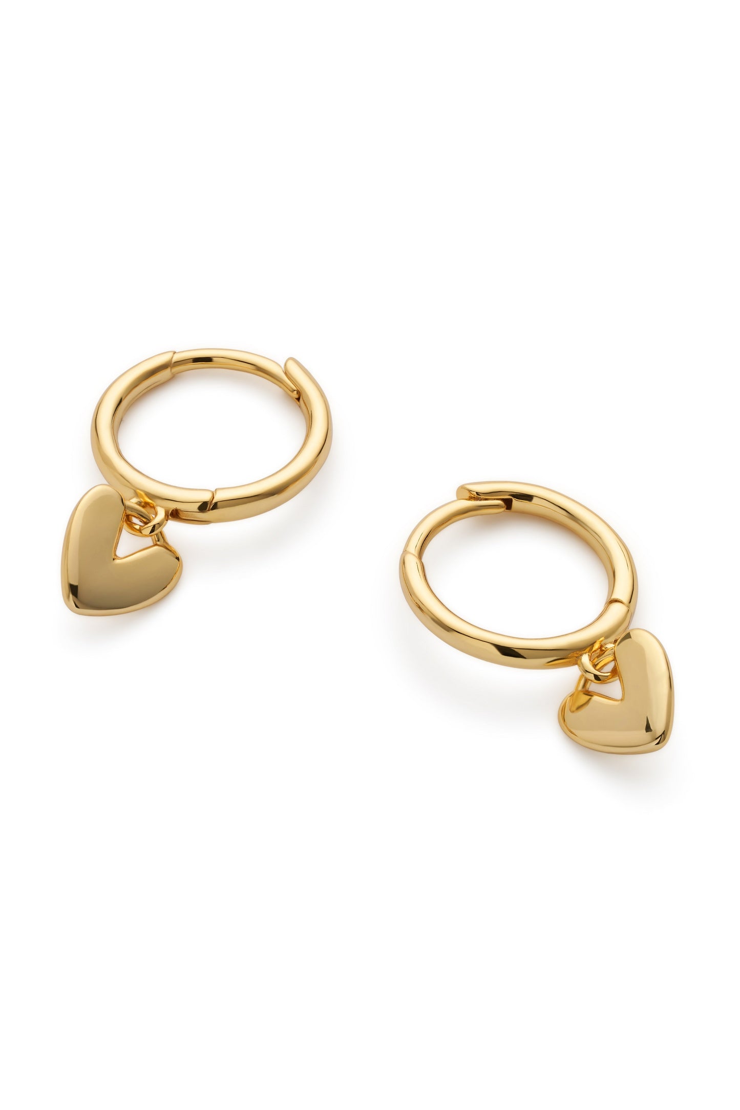 Close-up of dainty gold heart drop on hoop earring