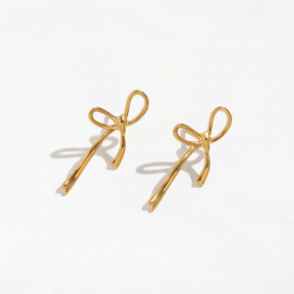 Wandering Bow gold drop earrings by Ravyena