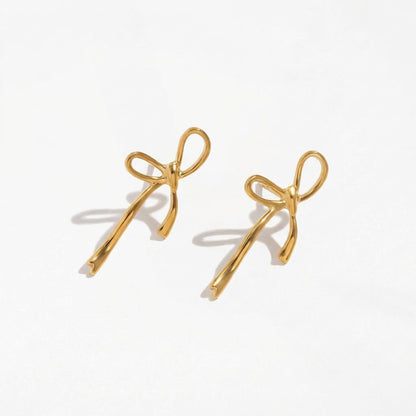 Wandering Bow gold drop earrings by Ravyena