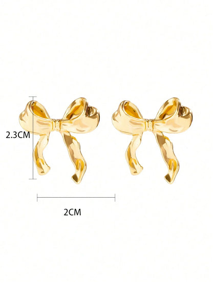 Gold bow earrings — playful and feminine, side angle