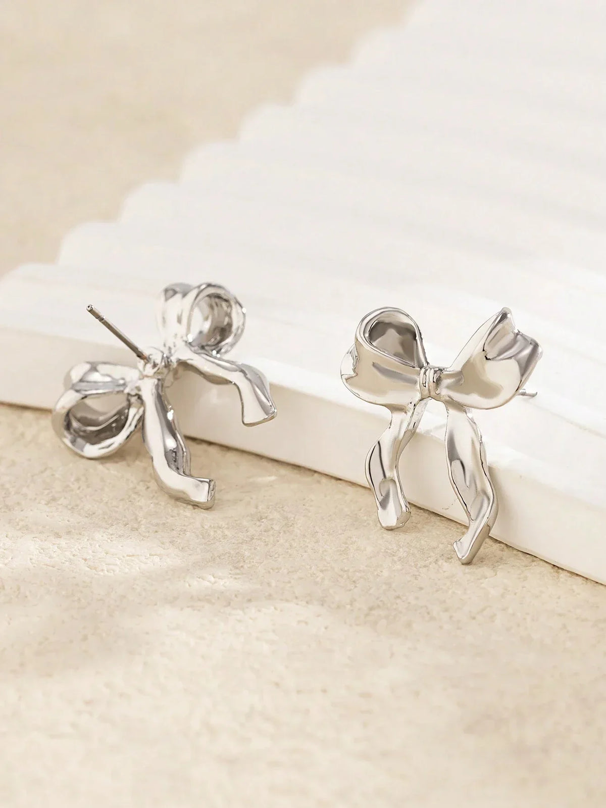 Delicate gold bow stud earrings, refined finish