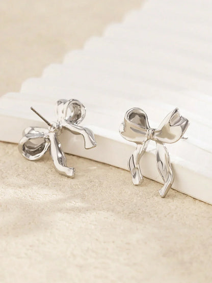 Delicate gold bow stud earrings, refined finish