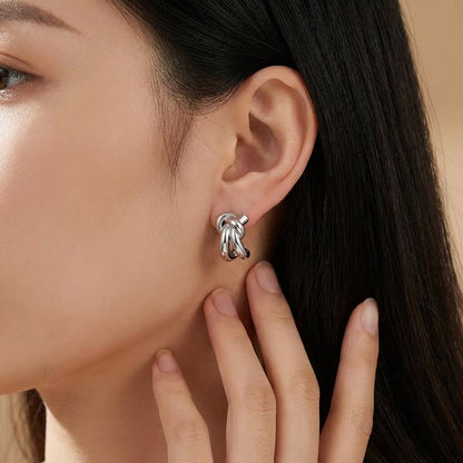 Knot huggie earrings stacked along the ear – Vessaly