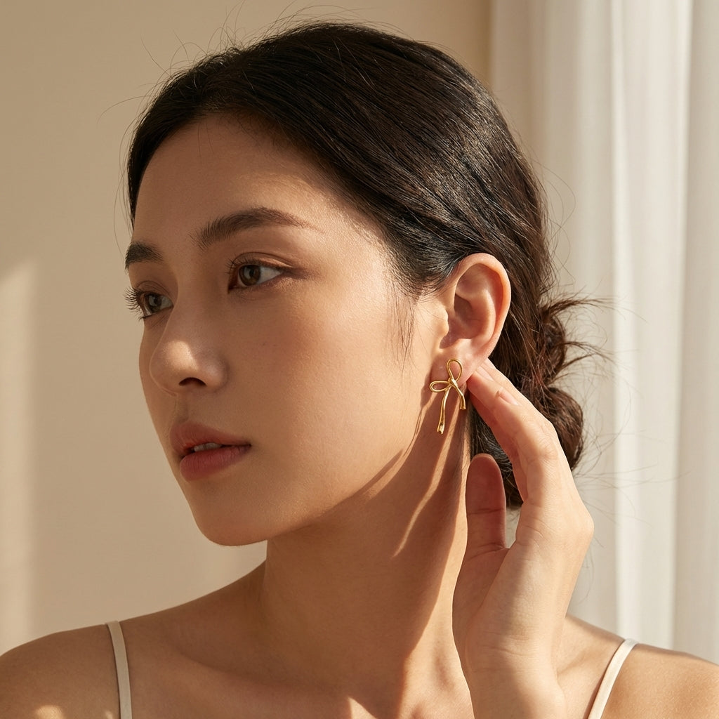 Ravyena Wandering Bow earrings styled on model