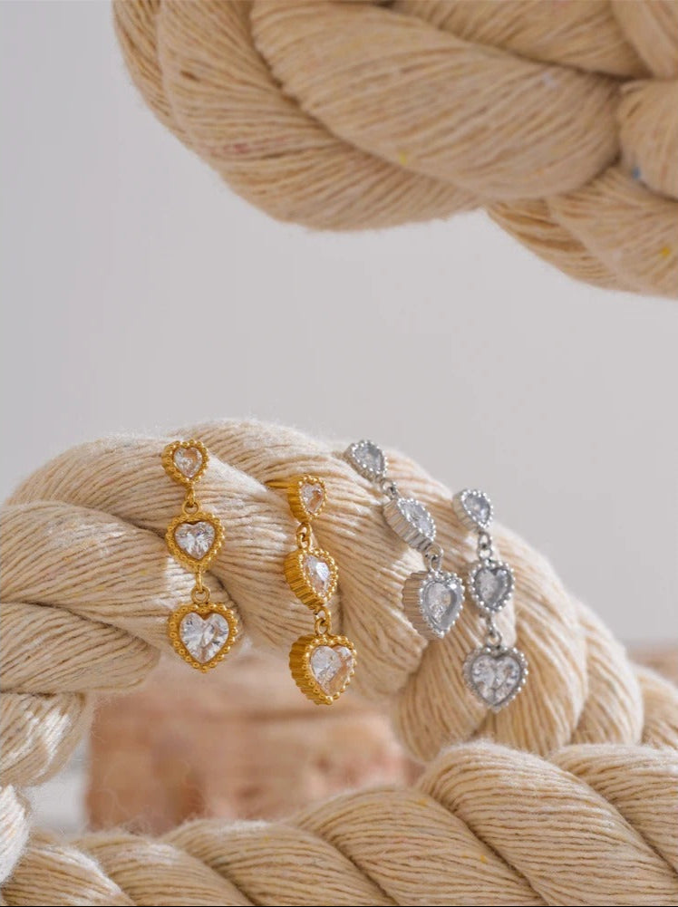Trinity of hearts earrings detail shot, gold finish