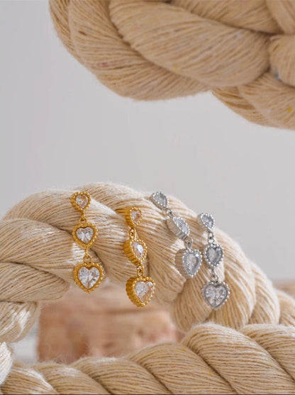 Trinity of hearts earrings detail shot, gold finish