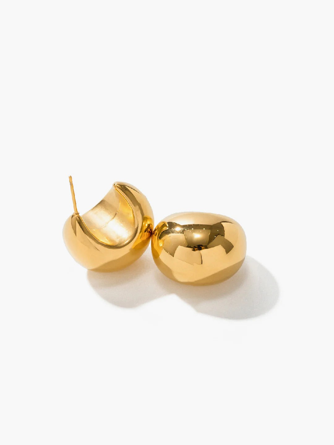 Gold dome drop earrings — sculptural side angle view