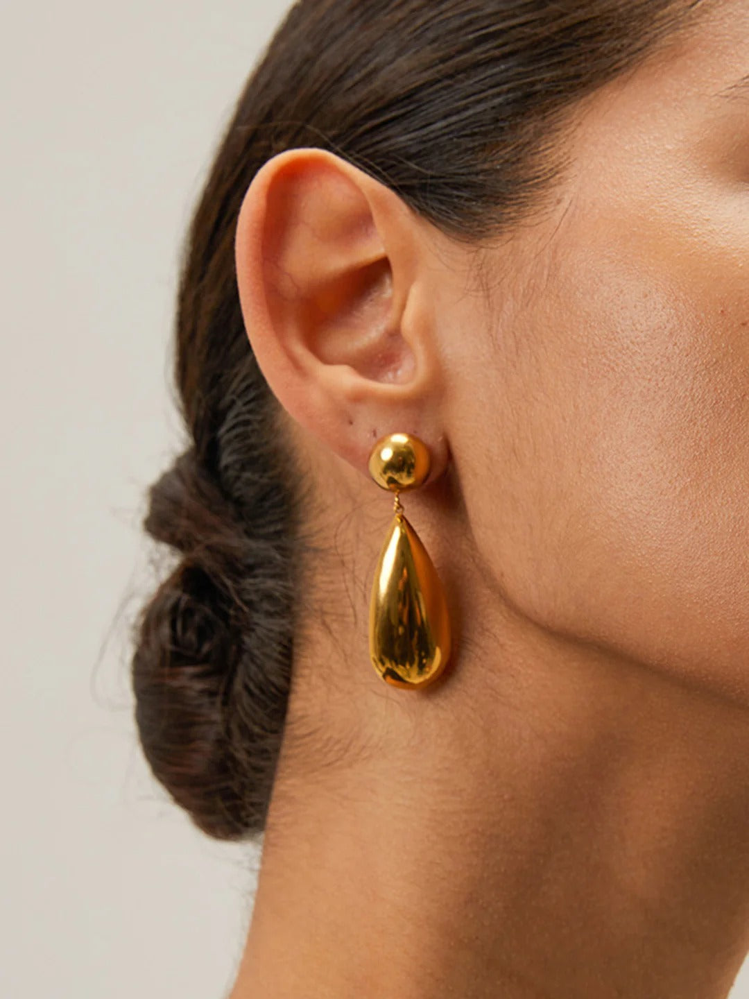Gold teardrop earrings with polished finish