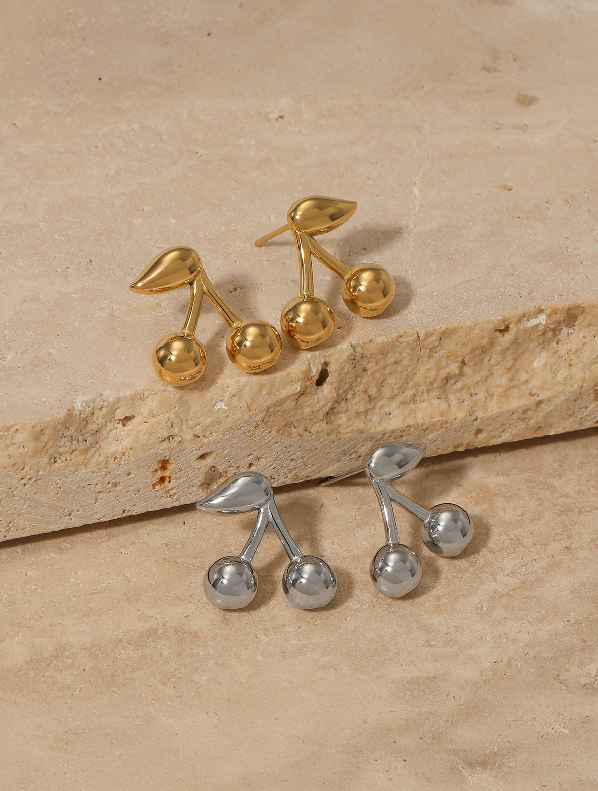 Cherry studs on neutral background, refined finish