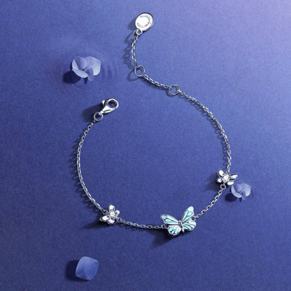 Close-up of luminous enamel butterfly charm detail