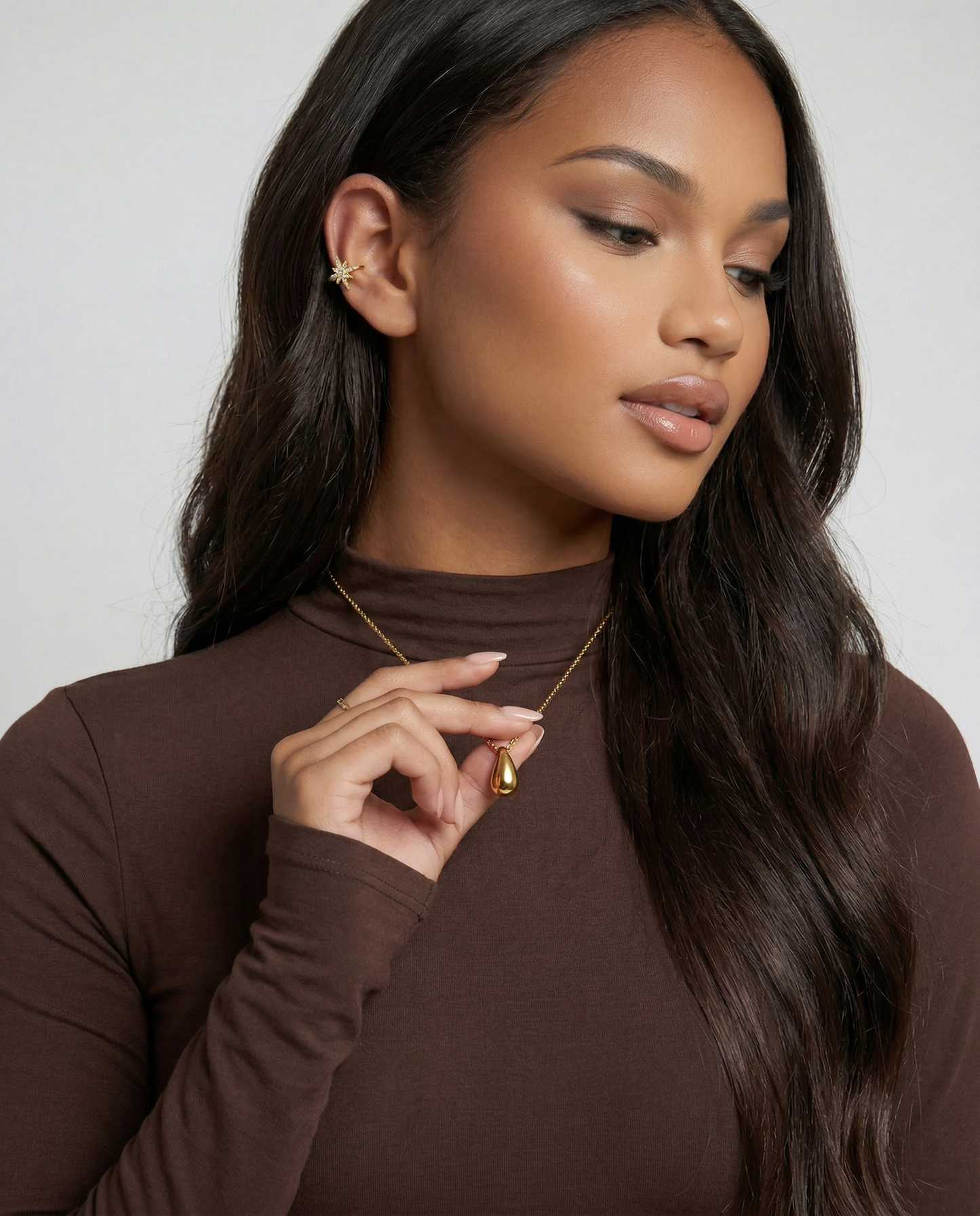 Gold teardrop necklace shown with paired piece