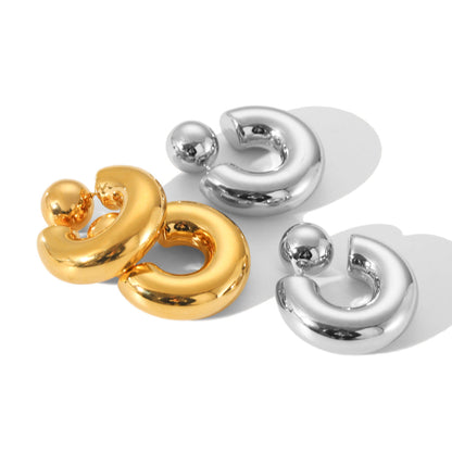 Sculptural C-shaped earring against neutral background