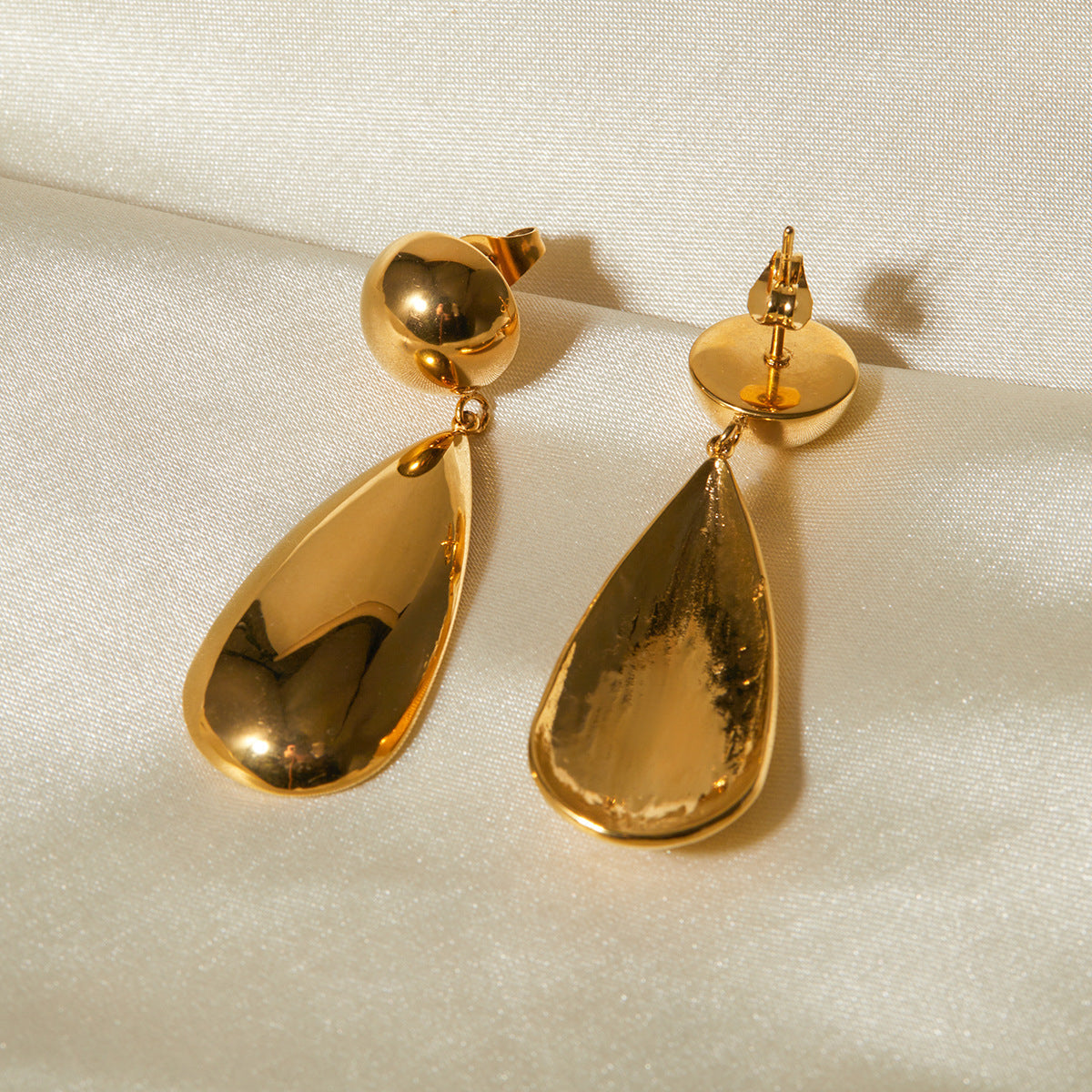Goccia earrings styled on a model's ear