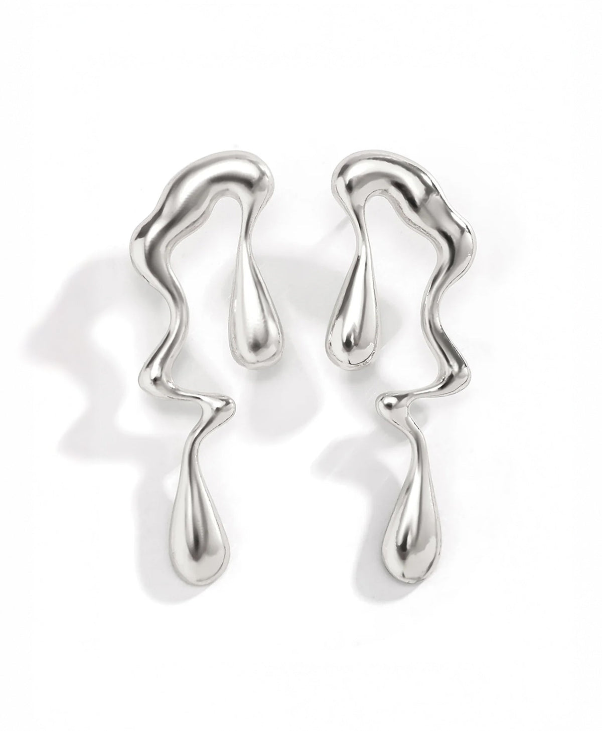 Lustrous Flow drop earrings in silver — on neutral background