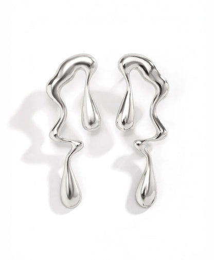 Lustrous Flow drop earrings in silver — on neutral background