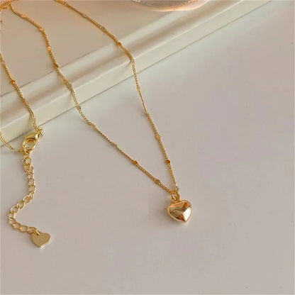 Love pendant clavicle necklace styled on neckline – Vessaly