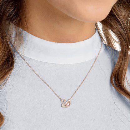 Rose gold swan necklace styled on neckline – Vessaly