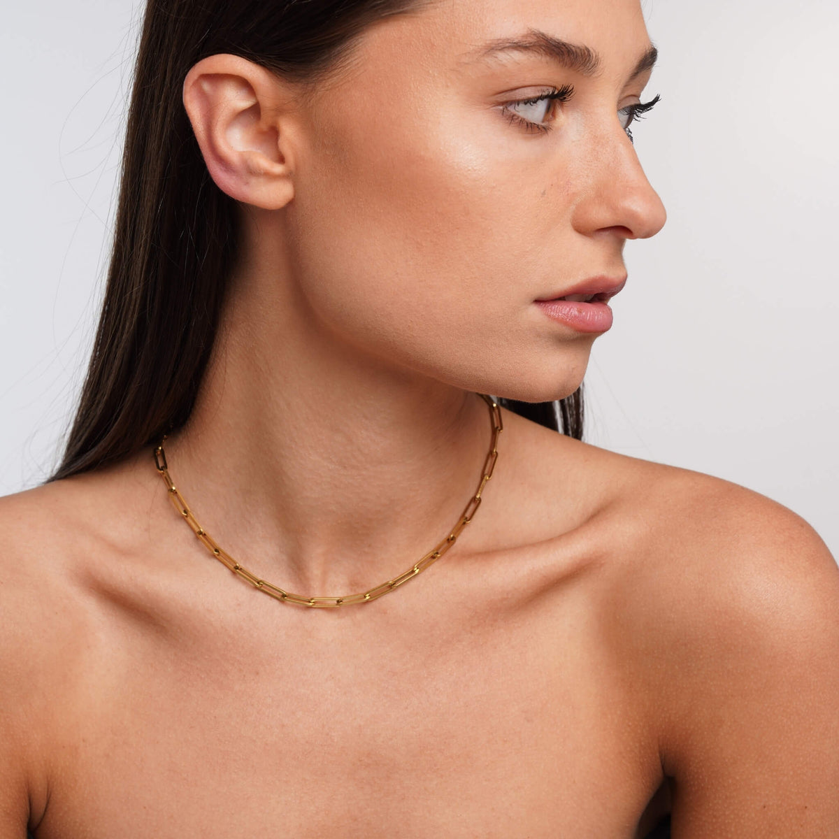 Gold link necklace styled on a model – Vessaly