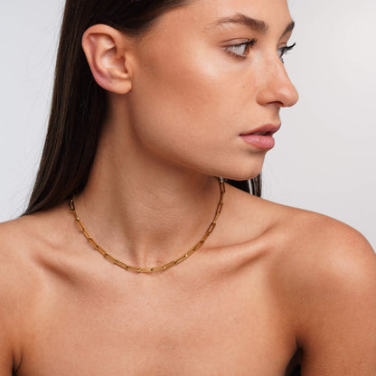 Gold link necklace styled on a model – Vessaly
