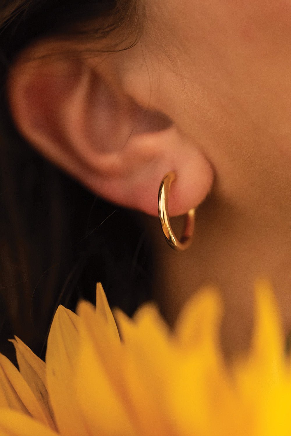 Delicate gold hoop earrings close-up – Vessaly