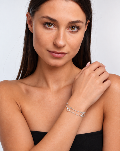925 silver two-chain heart charm bracelet worn on model, three-quarter view