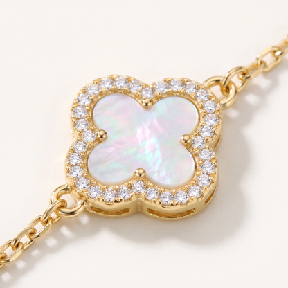 Macro close-up of mother-of-pearl clover with white sapphire pave in 18K gold vermeil