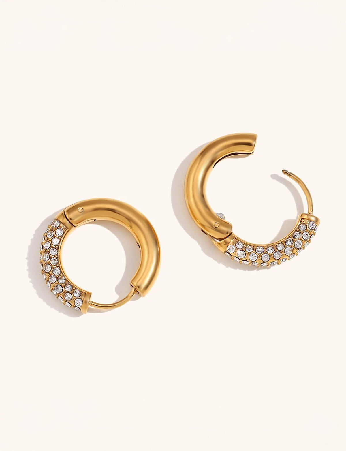Close-up of polished gold halo hoop with zirconia stone