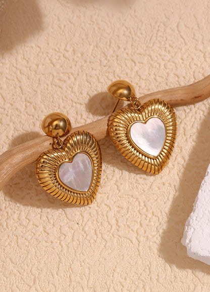 Heart drop earrings on neutral background