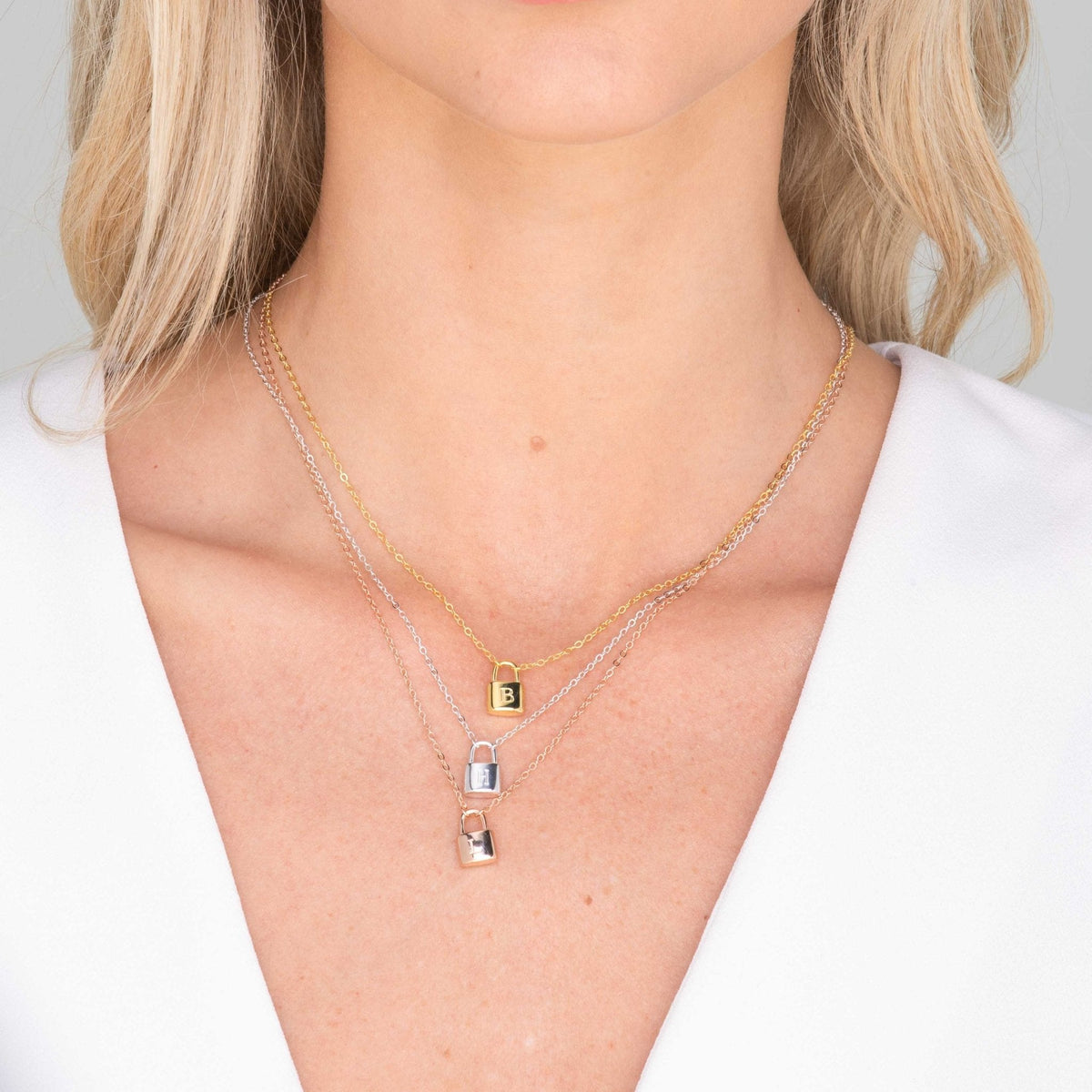 Padlock initial necklace styled on neckline – Vessaly