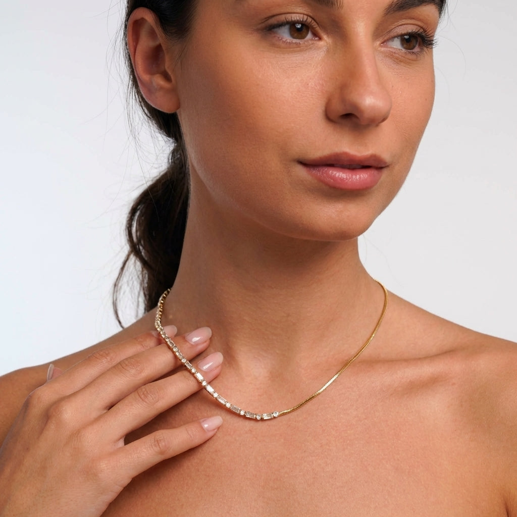 Gold crystal tennis necklace styled on neckline – Vessaly