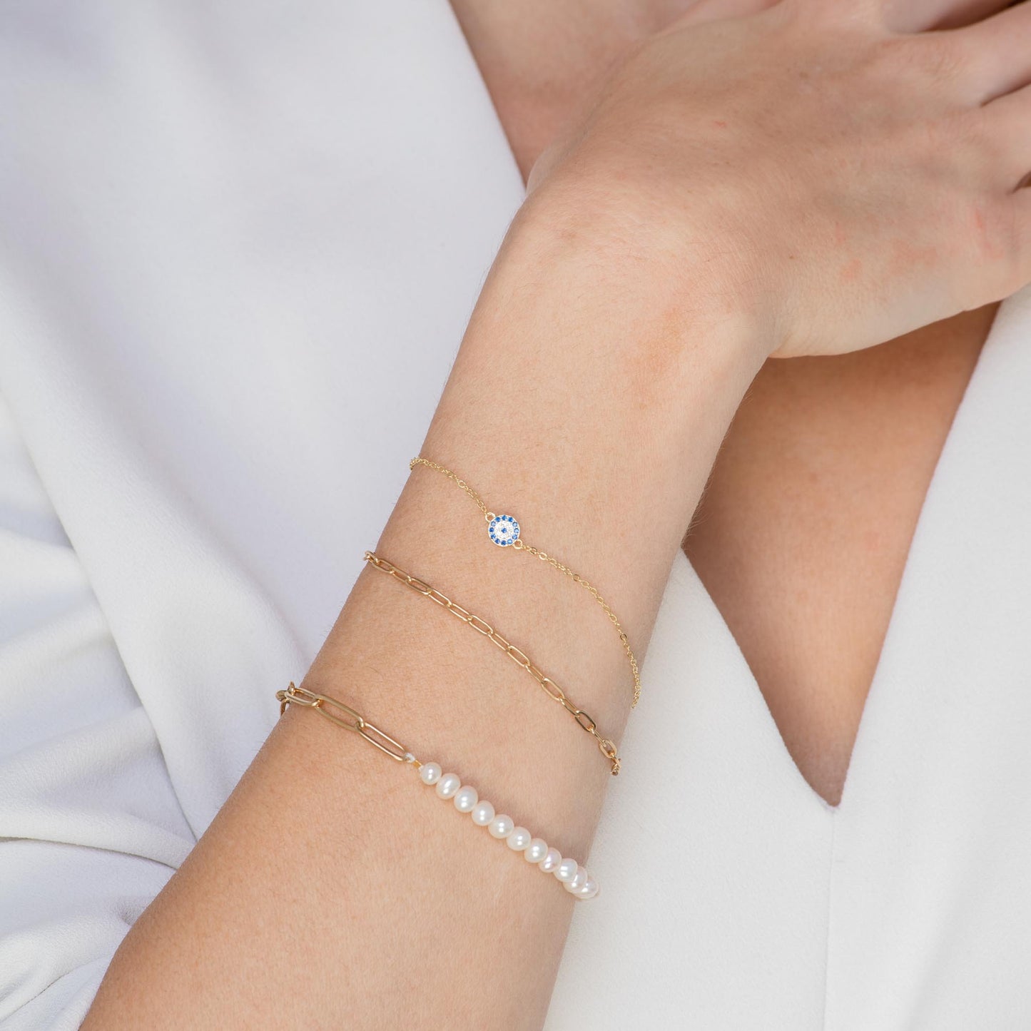 Gold evil eye charm bracelet with pave detail