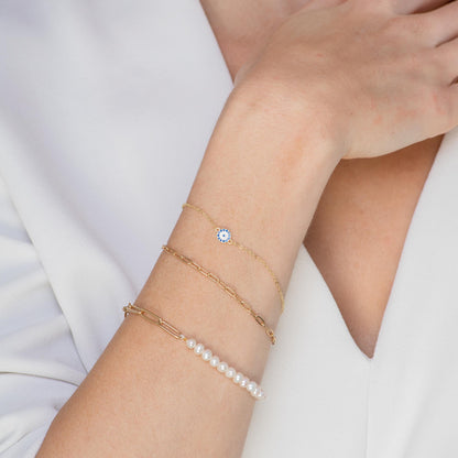 Gold evil eye charm bracelet with pave detail