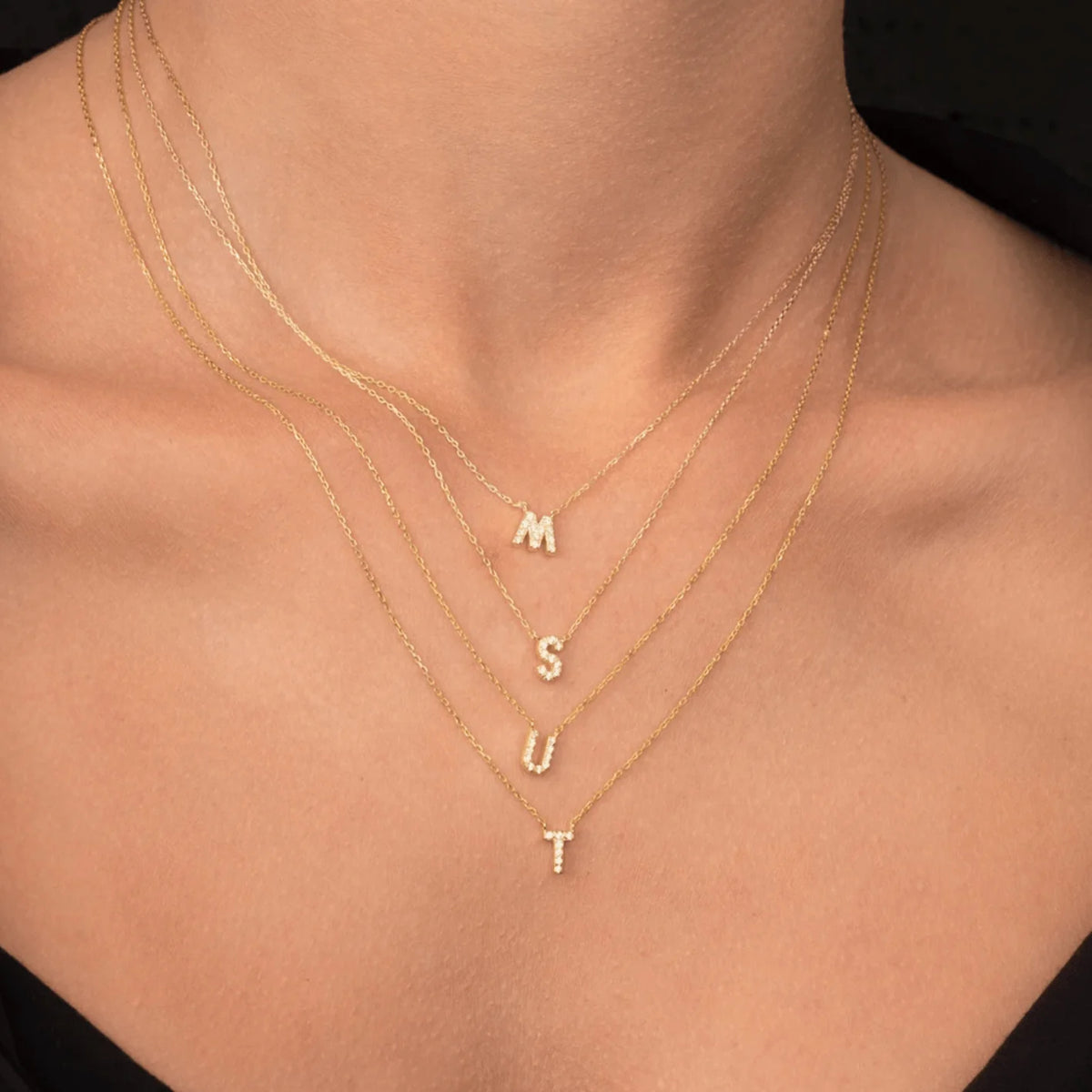 Sapphire initial necklace lifestyle shot, layered look