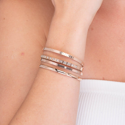 Slim clover bangle on neutral background