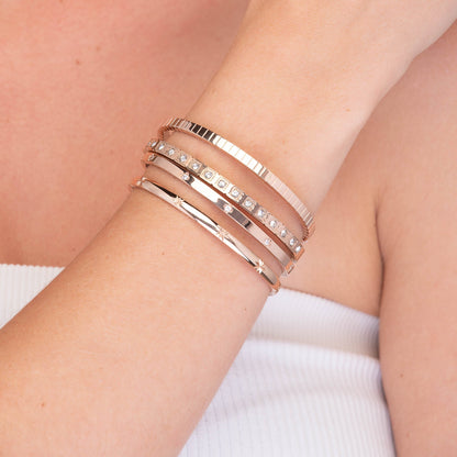 Gold hinged bangle with zirconia stones