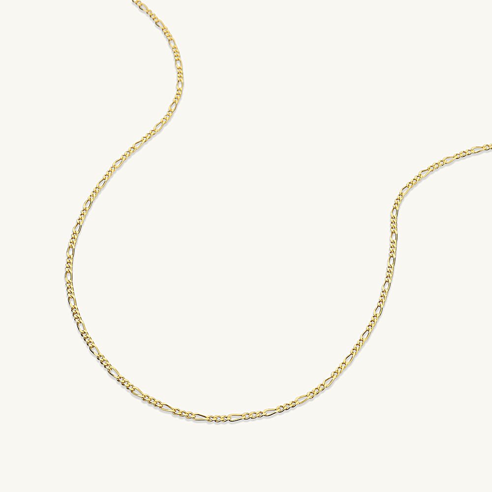 Slim figaro necklace styled on a model's neckline