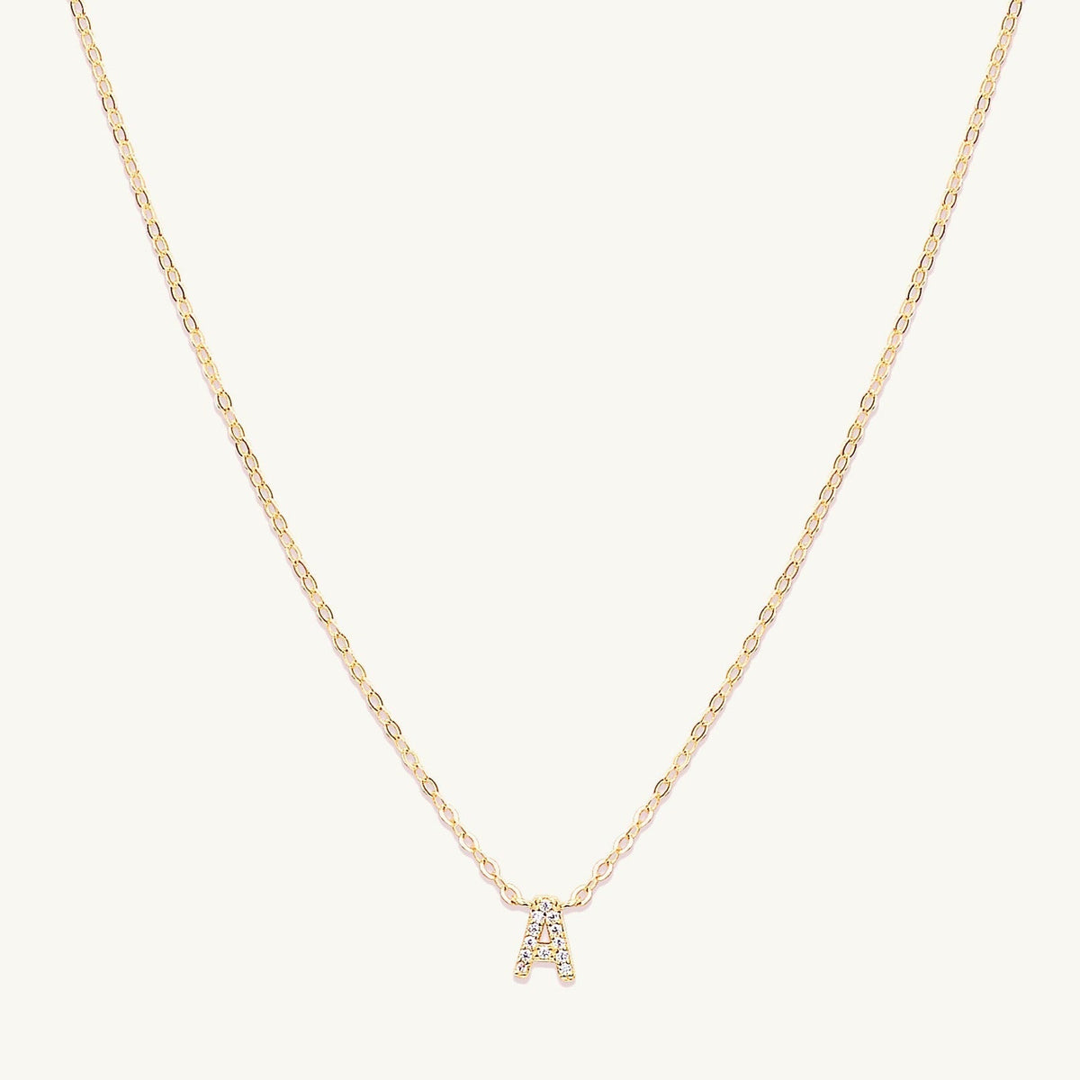 Sapphire letter necklace variation H on a delicate gold chain