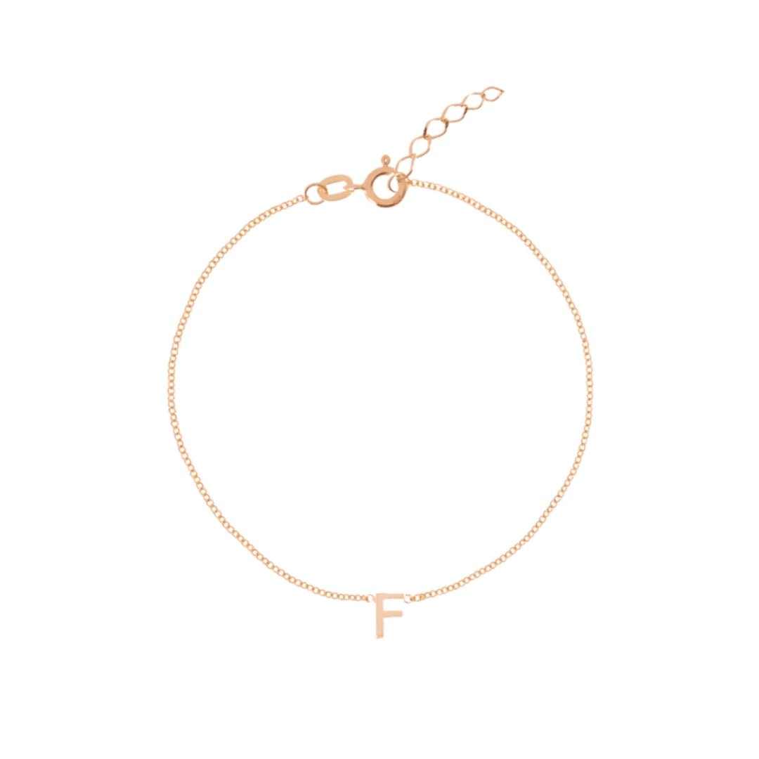 Letter bracelet on neutral background