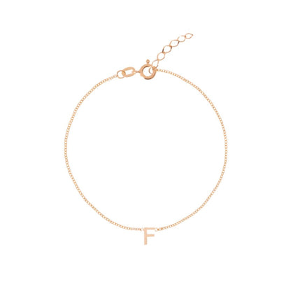 Letter bracelet on neutral background