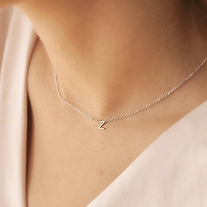 Gold initial necklace styled with everyday outfit