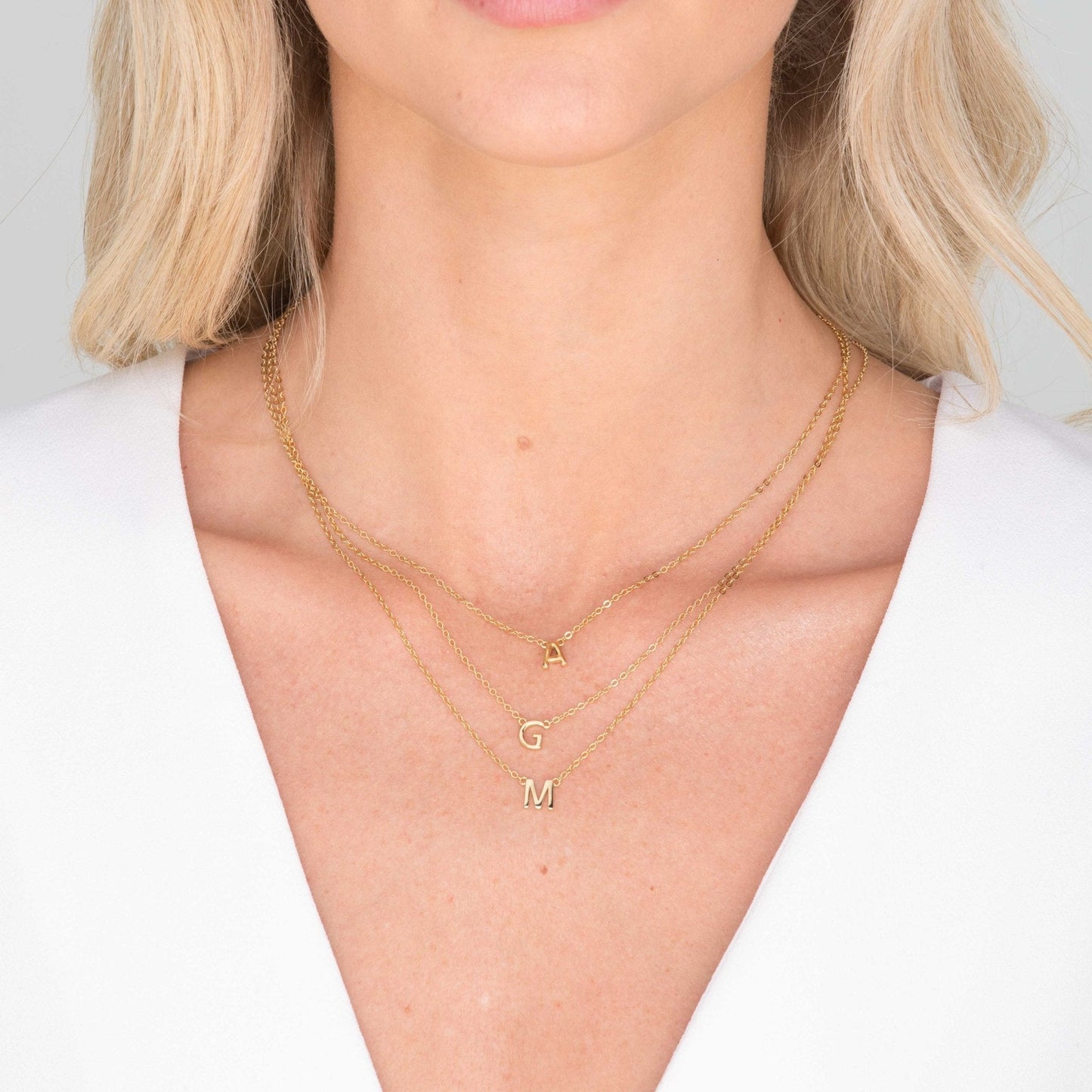 18K gold vermeil initial necklace on neutral background