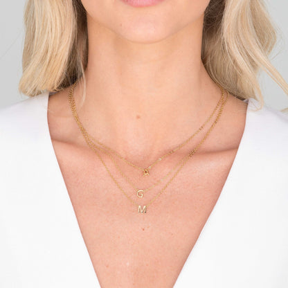 18K gold vermeil initial necklace on neutral background