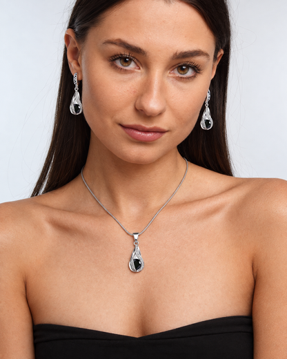 Black Crystal Twist Necklace & Earring Set in Black, worn by a model in a front portrait - Vessaly