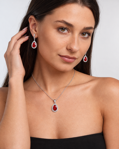 Color Crystal Teardrop Necklace & Earring Set in Red, worn by a model in a three-quarter portrait - Vessaly