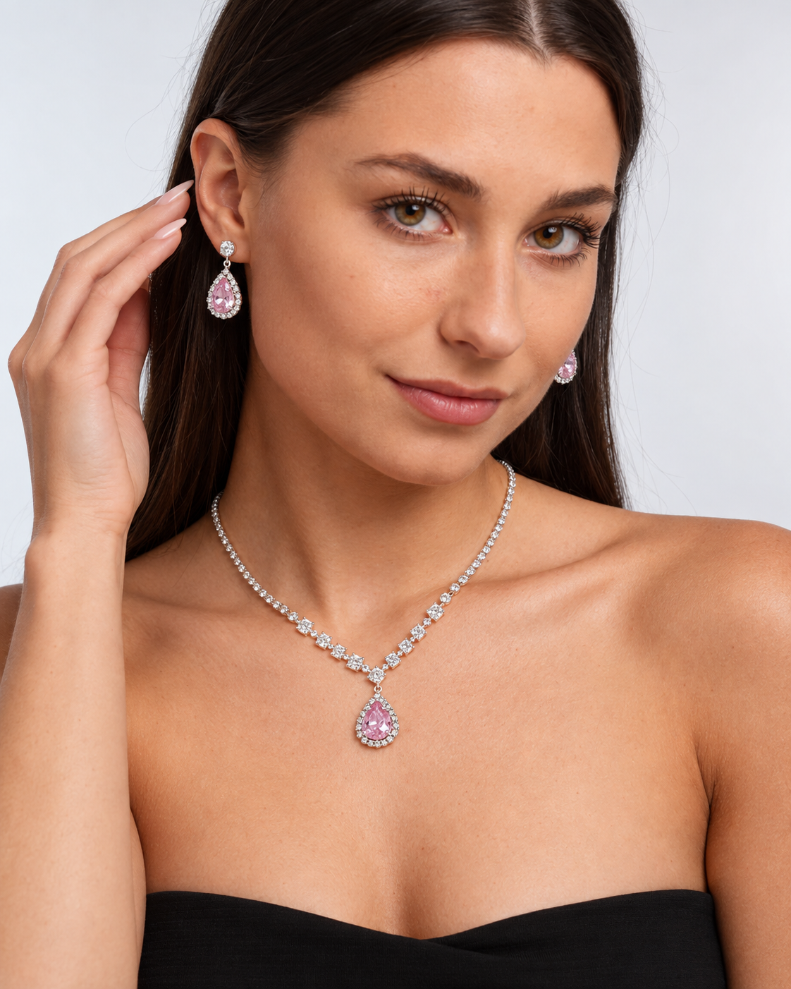 Crystal Teardrop Necklace & Earring Set in Silver / Pink, worn by a model in a three-quarter portrait - Vessaly