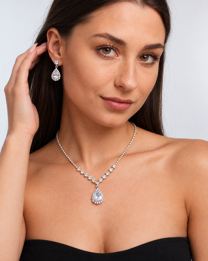 Crystal Teardrop Necklace & Earring Set in Silver / Clear, worn by a model in a three-quarter portrait - Vessaly
