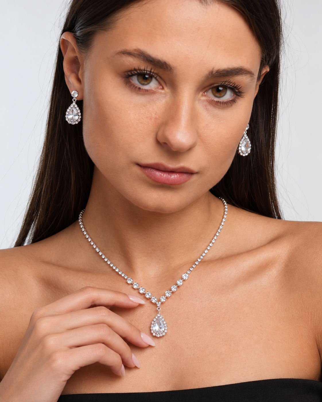 Crystal Teardrop Necklace & Earring Set in Silver / Clear, worn by a model in a close-up - Vessaly