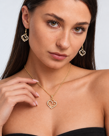 Double Heart Crystal Necklace & Earring Set in Gold, worn by a model in a close-up - Vessaly